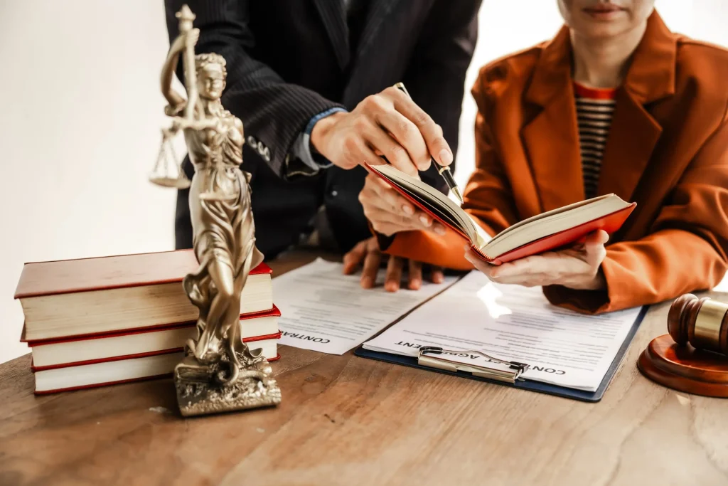 In the office, at the desk, colleagues review legal documentation on civil law contracts.
