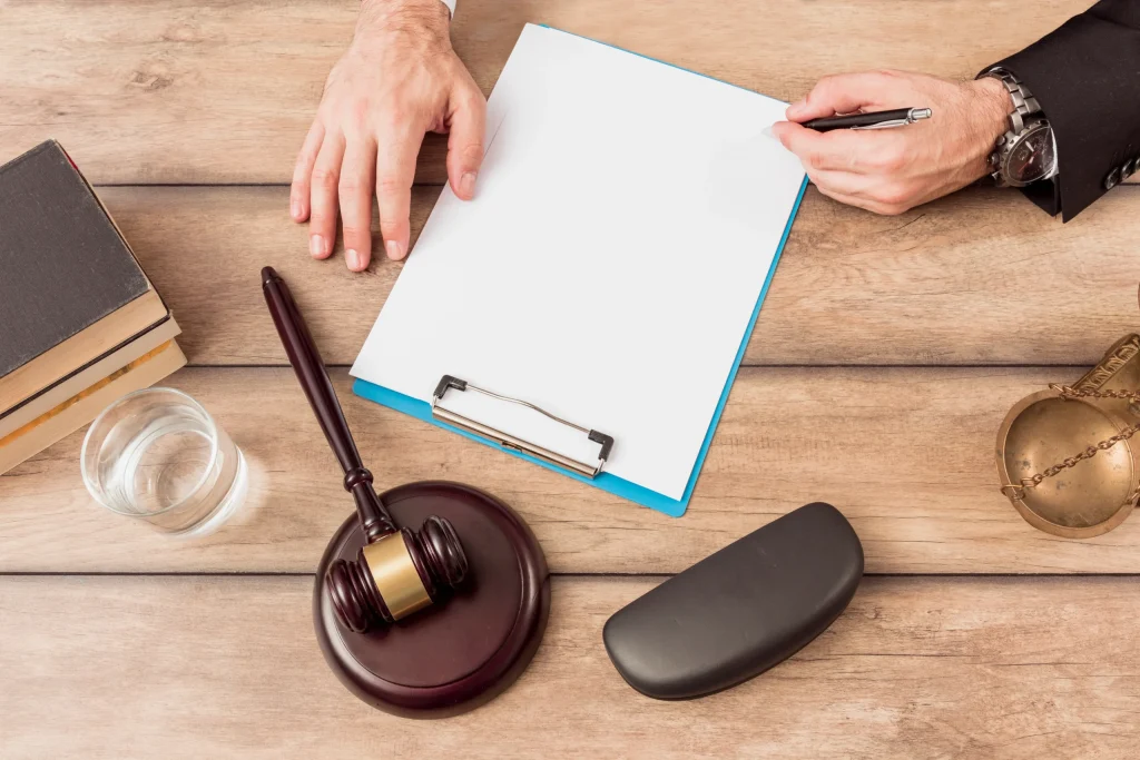 Legal document to be signed on a desk with a judge's gavel and legal books, a symbol of labor law procedures.