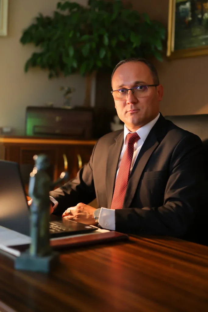 Saša Levnajić, a lawyer from Pancevo, is shown sitting at his desk at his laptop.